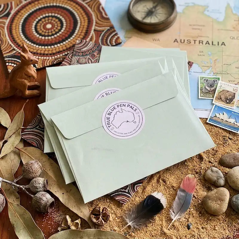 Contents of a True Blue Pen Pals adventure envelope including Australian story letter, maps, activities and keepsake collector cards for children
