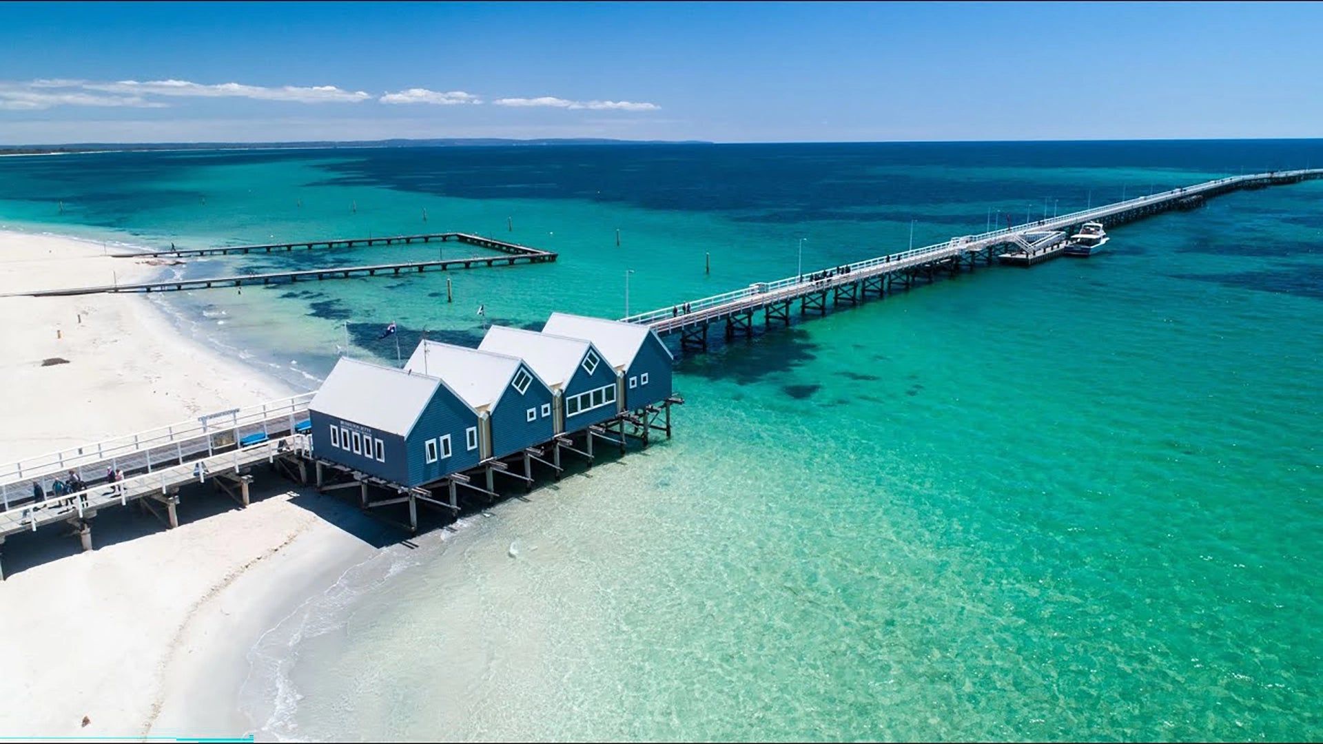 Busselton Jetty stretching 1.8 kilometres across the crystal clear turquoise waters of Geographe Bay in Western Australia, the longest wooden jetty in the southern hemisphere and one of Australia's most iconic coastal landmarks